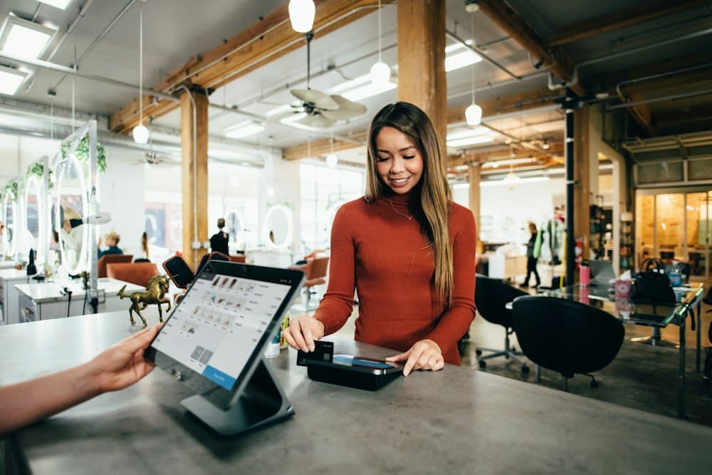 A customer paying by card at a point-of-sale terminal