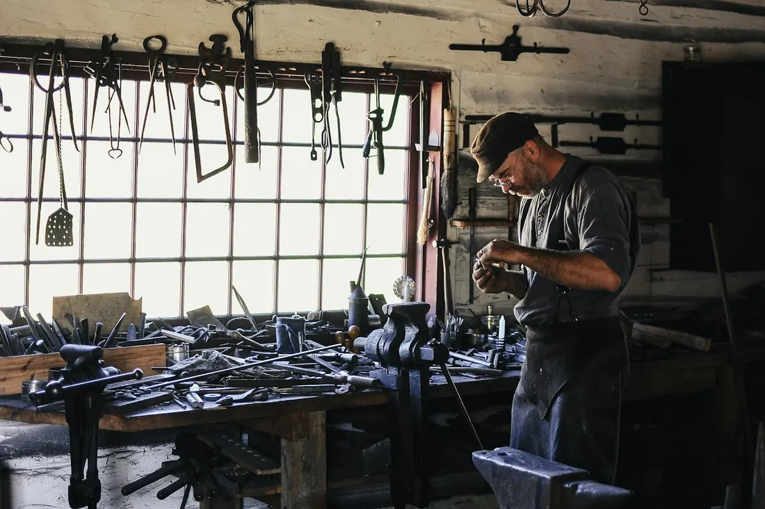A craftsman working at a bench in his workshop